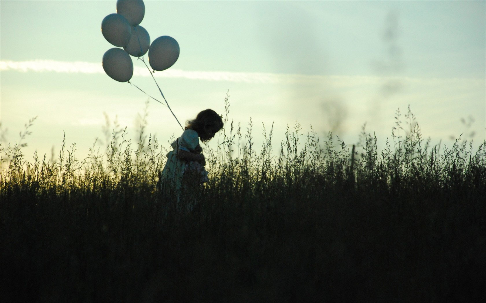 Little girl holding balloon desktop background